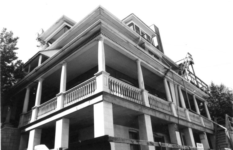 Detailed view of the John Stocks Residence featuring balcony and turret. Captured in 2013.