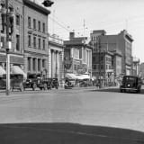 Historic view of Edmonton on 101 Street in 1930, showcasing the street's architecture and atmosphere.