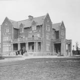 Side view of Government House in 1912, showcasing the greenhouse, captured by the City of Edmonton Archives.