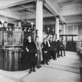 Interior view of the Merchants Bank of Canada, circa 1906, showing banking details.