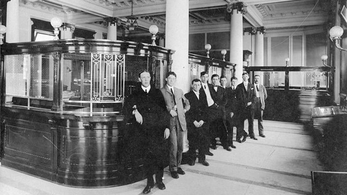 Interior view of the Merchants Bank of Canada, circa 1906, showing banking details.
