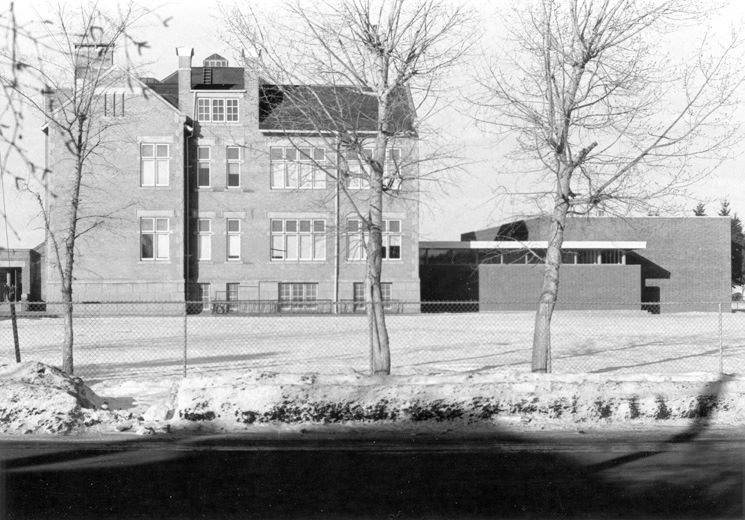 Exterior view of Oliver School showing the side elevation with the International addition, taken in 1968.